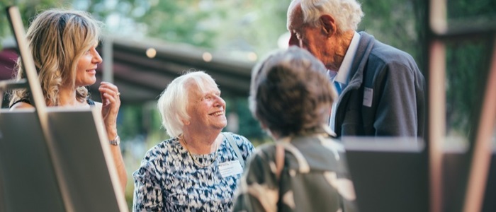 Gifts in wills A multi-generational family stand around talking