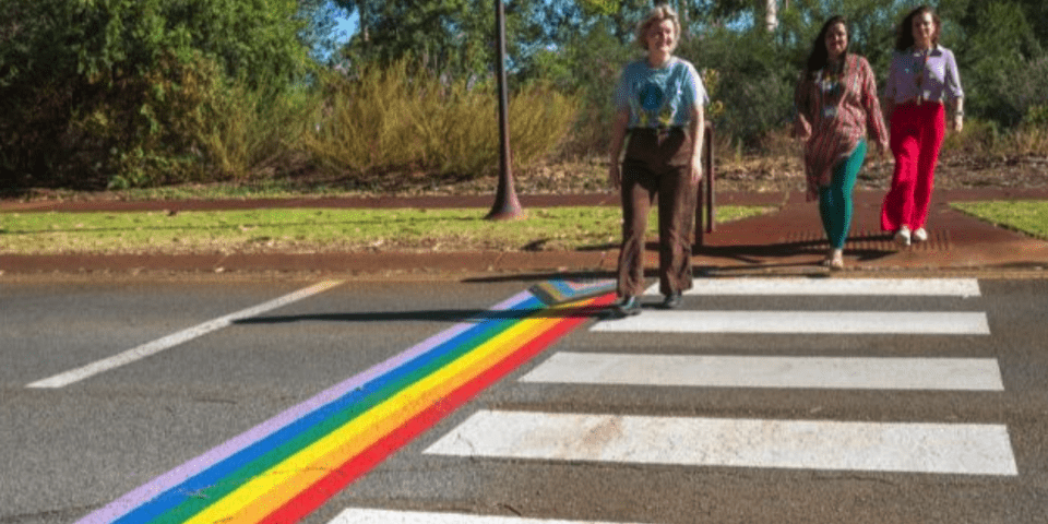 students walking across pride crossing