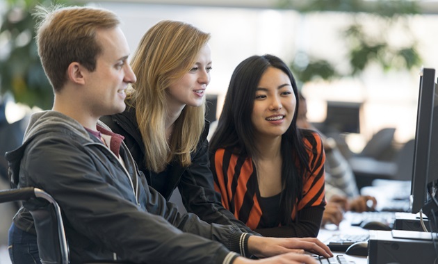 students looking at computer talking