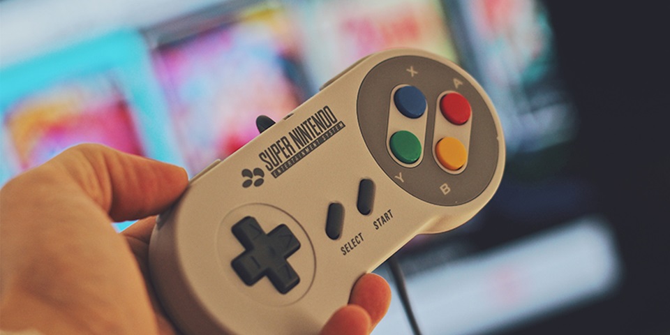 90s gaming console feature Hand holding 90s gaming console