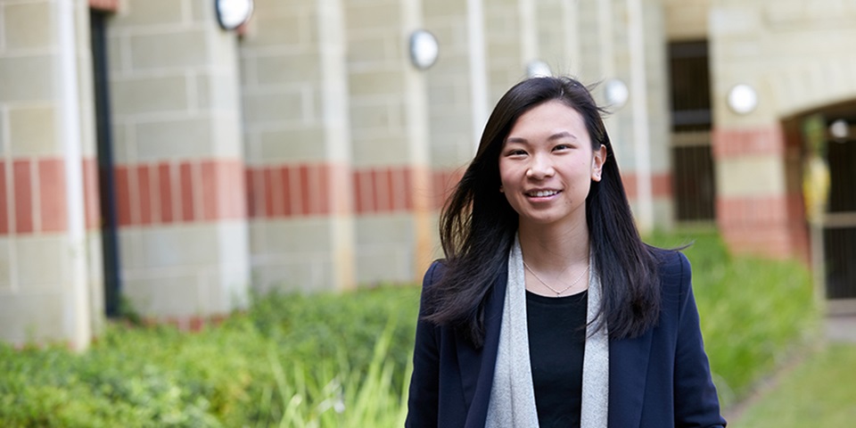 Andra Julinar Feature Image International student Andra Julinar smiling and posing in front of building at Murdoch Perth campus