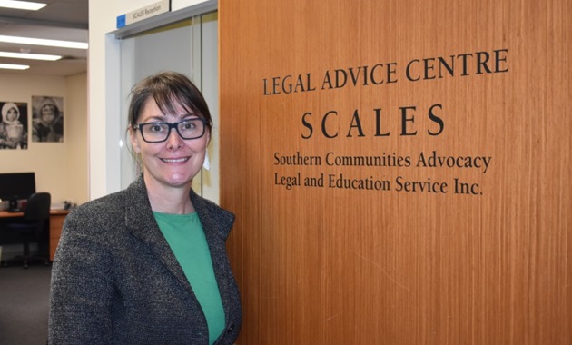 Anna Copeland standing in front of SCALES Clinic sign