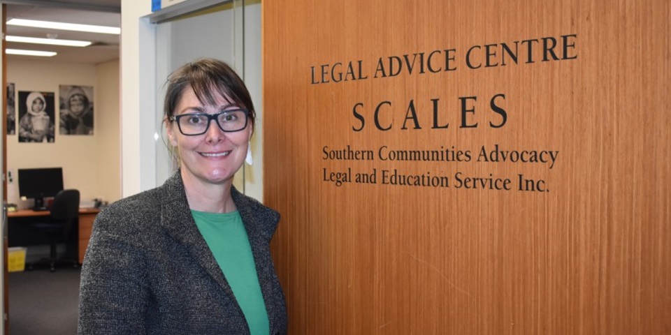 Anna Copeland standing in front of SCALES Clinic sign Anna Copeland standing in front of SCALES Clinic sign