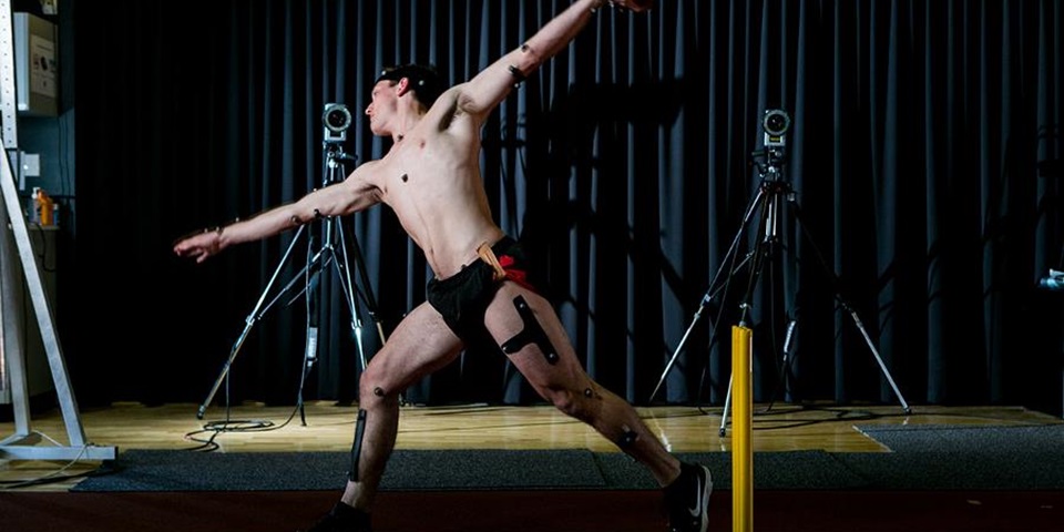 Athlete bowling Cricket player bowling with electrodes attached for gait analysis