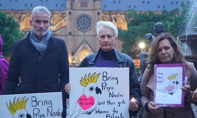 Protesters holding placards to support the Murugappan family