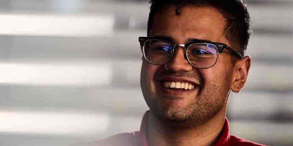 Business Feature 860x480 Person wearing glasses smiling