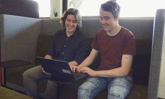 Murdoch IT students Chad and Nathan working on a laptop