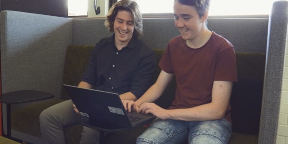 Murdoch IT students Chad and Nathan working on a laptop