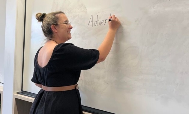 Student writes on whiteboard