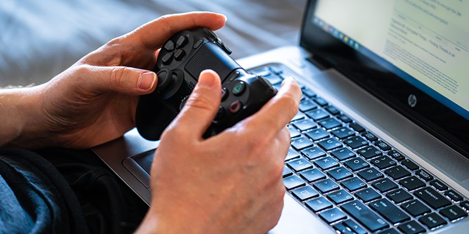 Child using video game handset with computer feature Child using video game handset with computer