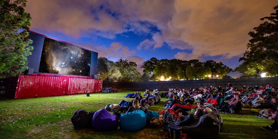 Guests on beanbags enjoy an evening movie at Murdoch's outdoor cinema