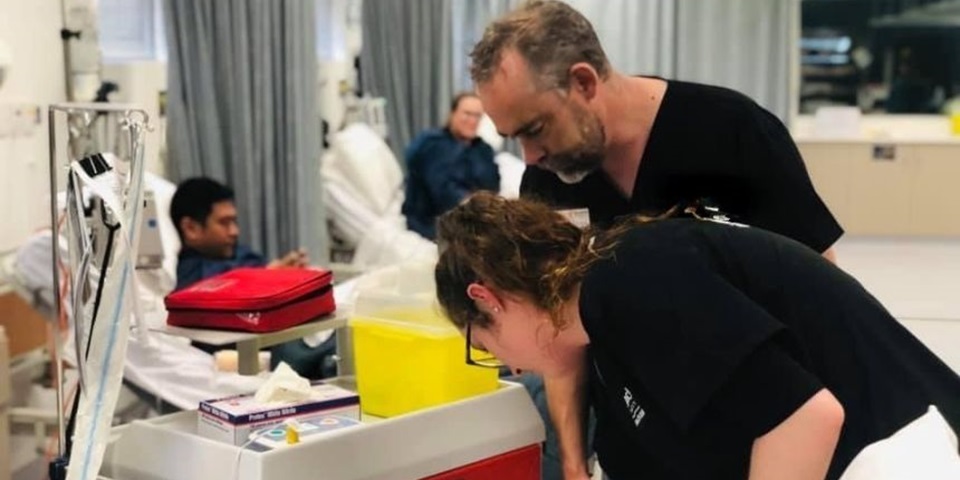 Teacher and student work in a simulated hospital room