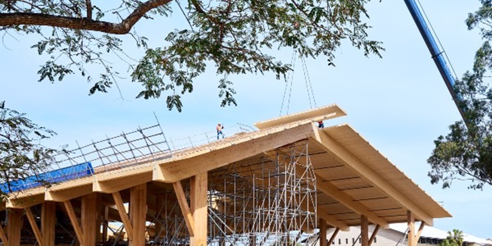 Crane lifting the final piece of timber onto the Northern Plaza of Boola Katitjin