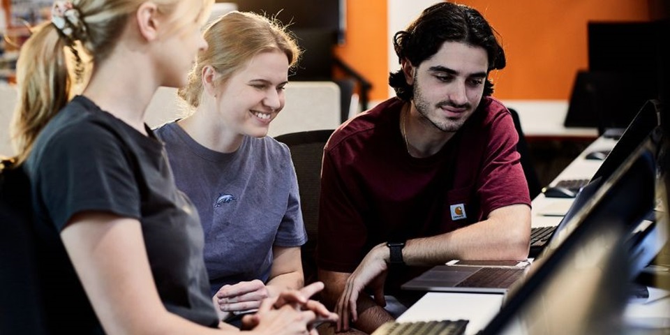 Creative Arts Career Influencer feature Group of students crowded around piano