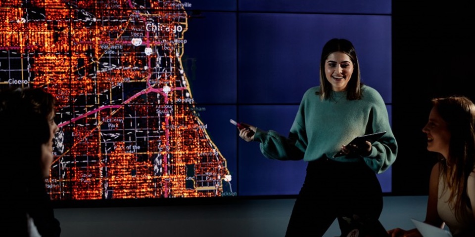 Criminology_Job_Feature Female student presenting in front of a map of Chicago
