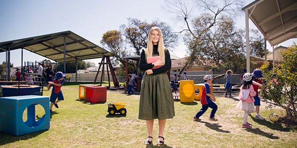 education-job-thumbnail Teacher standing in primary school playground.