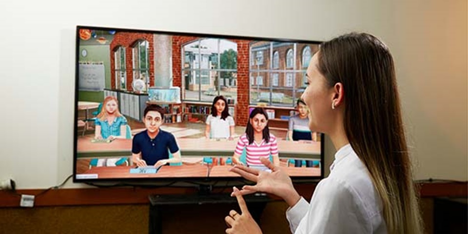 Student presents in front of a virtual classroom.