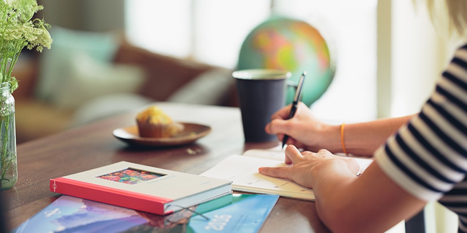 Feature image of woman sitting at a desk writing in a notebook Feature image of woman sitting at a desk writing in a notebook