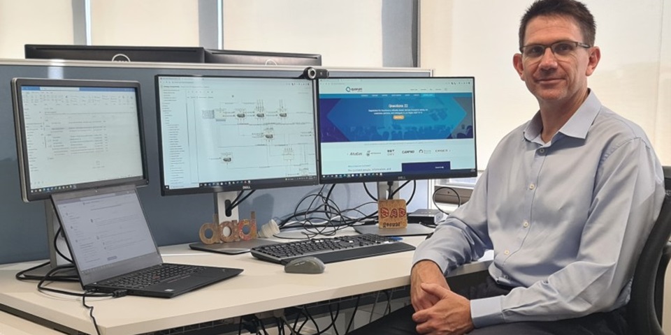 Feature Image - Russell Dunstan Russell Dunstan sitting in front of computer looking at camera