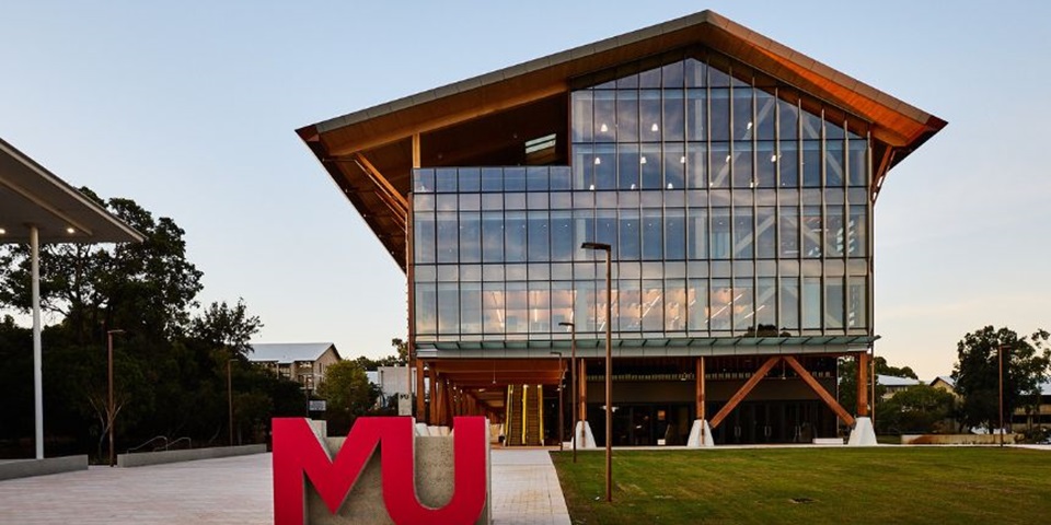 A photograph of the exterior of Boola Katitjin, featuring a MU shaped sculpture