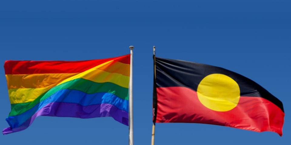 Pride flag and indigenous flag side by side