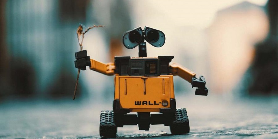 Friendly robot2 Toy robot holds up twig in his hands
