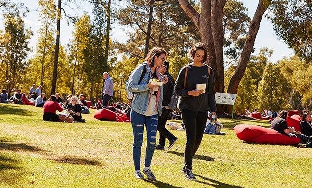 Two students walking across bush court