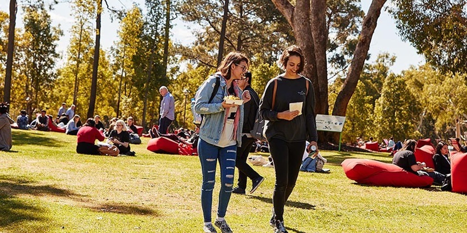 Two students walking across bush court