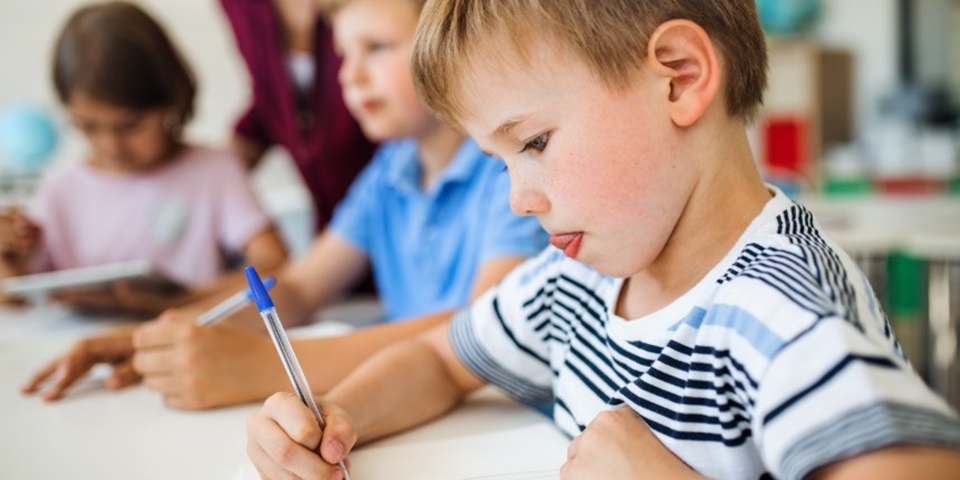 Young primary school boy handwriting