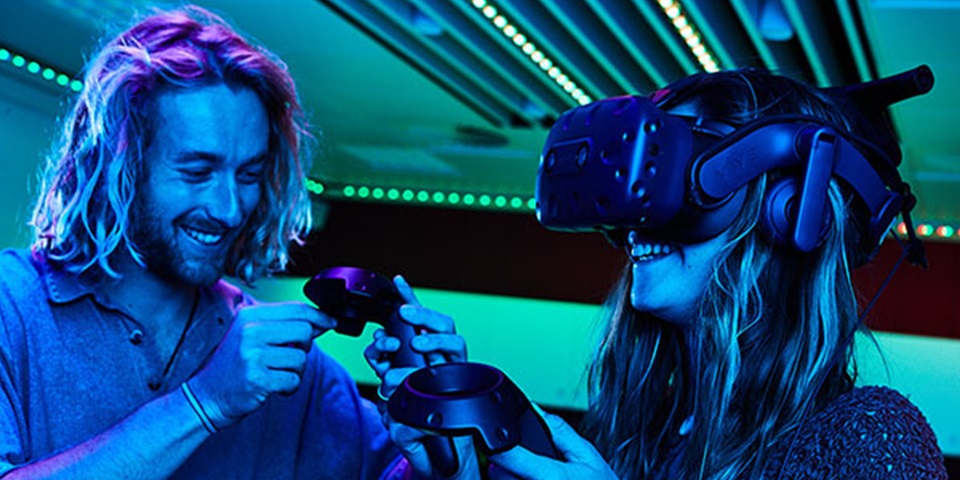 Male and female students using virtual reality headset.