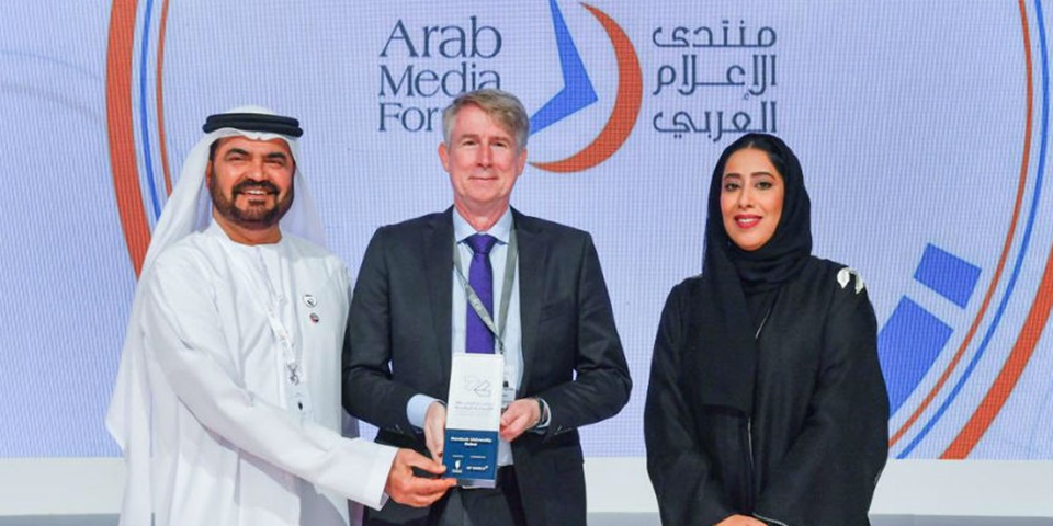 ames Trotter, Dean Murdoch University Dubai, receiving the award from HE Mona Al Marri, President of the Dubai Press Club, and HE Mohammed Al Muallem, CEO of DP World