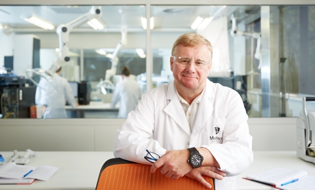 Jeremy Nicholson smiling in a lab coat at the Australian National Phenome Centre