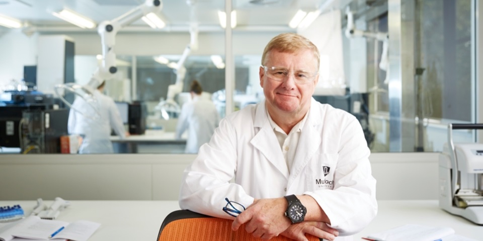 Jeremy Nicholson smiling in a lab coat at the Australian National Phenome Centre