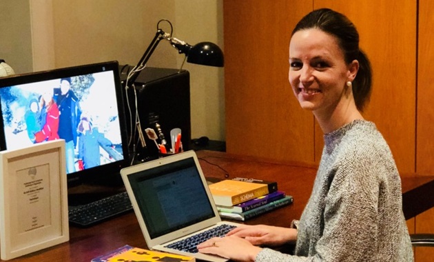 Kelli MacMillan at desk