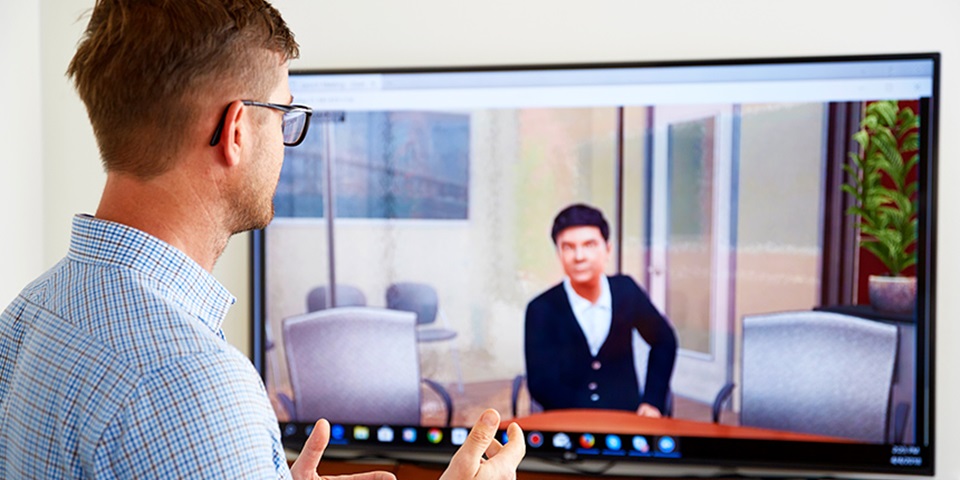 Man talking to computer screen feature Man talking to computer screen