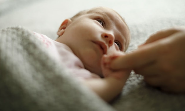 Mother holding baby's hand