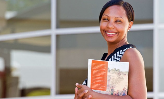 Smiling mature female student with brochure