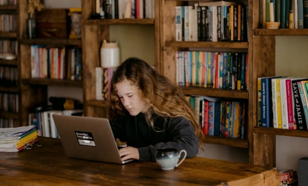 high school girl studying at table