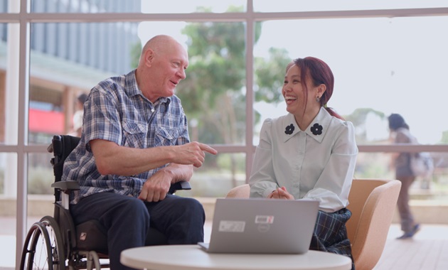 Steve Robinson and Dr May Aung-Htut discuss research findings in the foyer of the Personalised Medicine Centre at Murdoch University