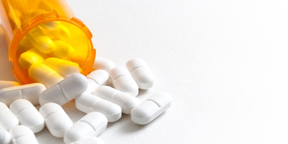 Pills falling out of orange container