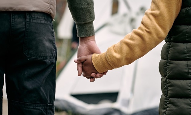 Parent and child holding hands - refugee and asylum seekers