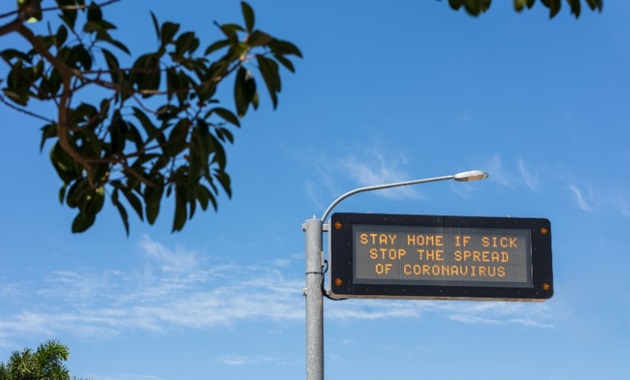 COVID-19 stay home warning road sign