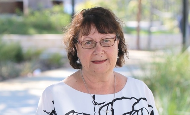 Rhonda Marriott standing in front of trees