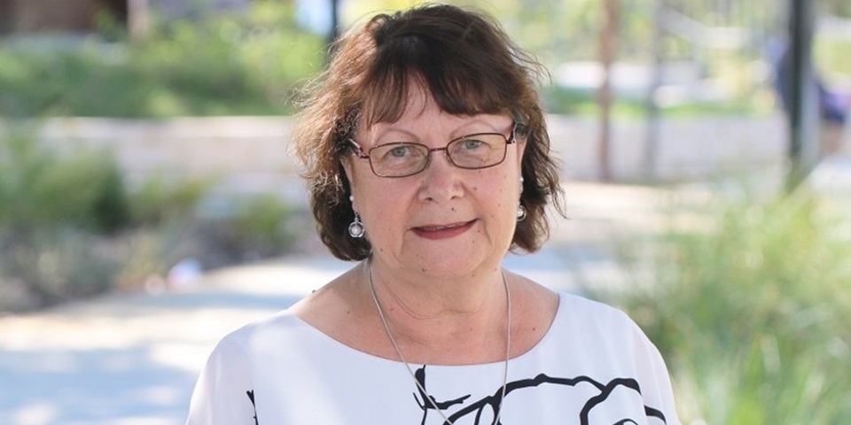 Rhonda Marriott standing in front of trees