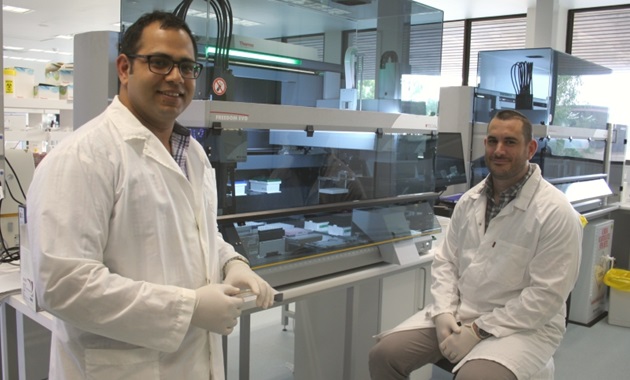 Associate Professor Sam Abraham and Dr Mark O?Dea standing near lab machinery