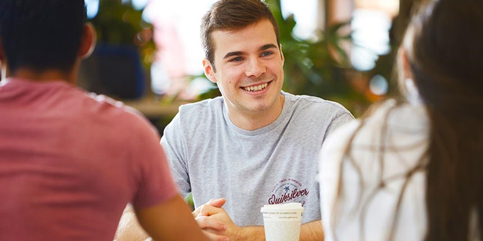 Scholarships-feature-860x480 Murdoch student sitting with friends drinking coffee