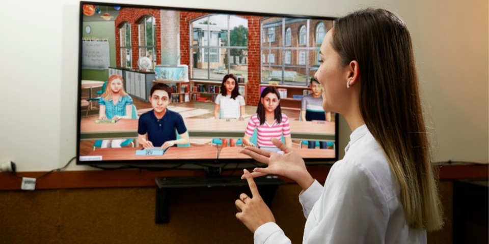 Woman standing in front of simlab screen