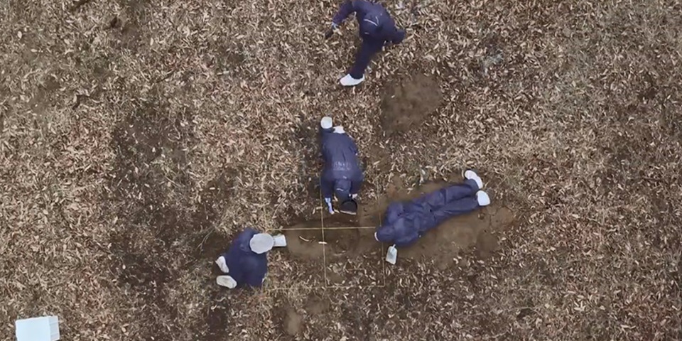 students excavating grave birds eye view of students excavating grave