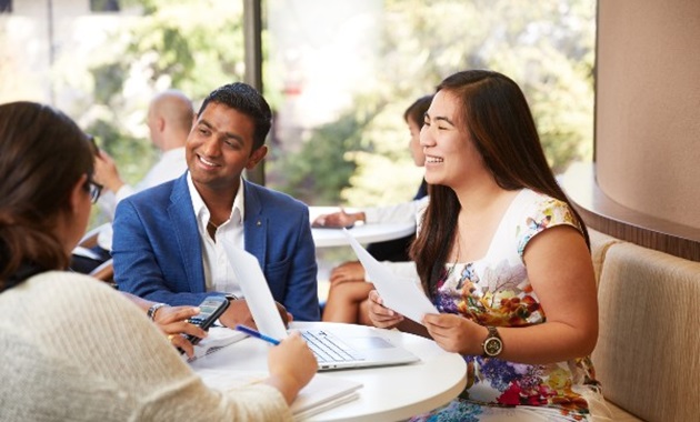 Students having a discussion around a table