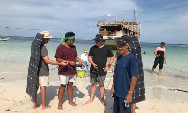 Murdoch University students demonstrate solar powered water kits to residents of  islands off Massakar, Indonesia